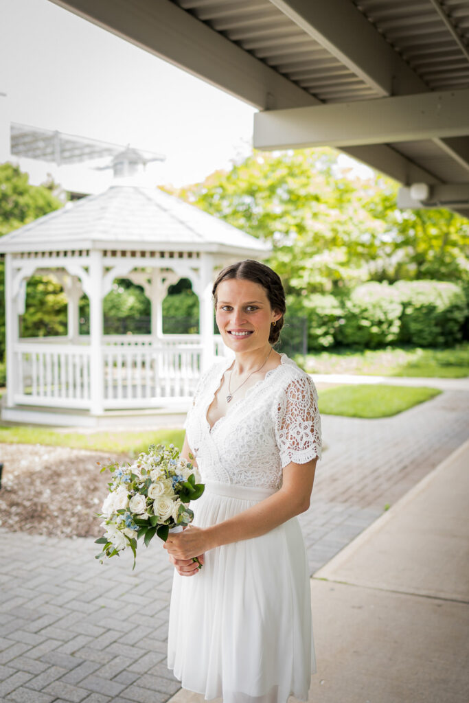 Bride holding white and blue bouquet at Hackensack courthouse wedding photographed by Alex Kaplan