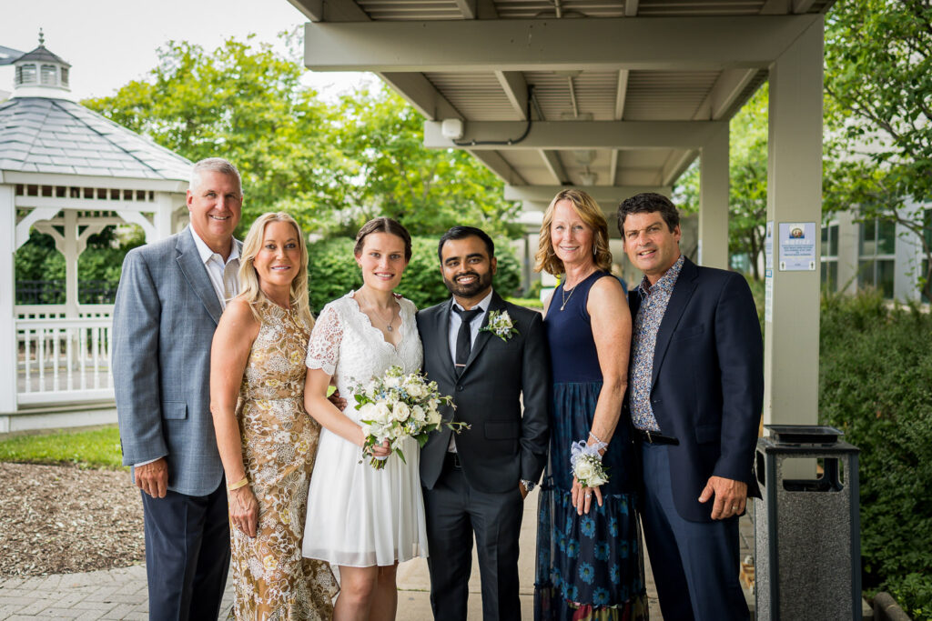 Courthouse wedding couple in formal attire with parents at Bergen County Plaza by Alex Kaplan