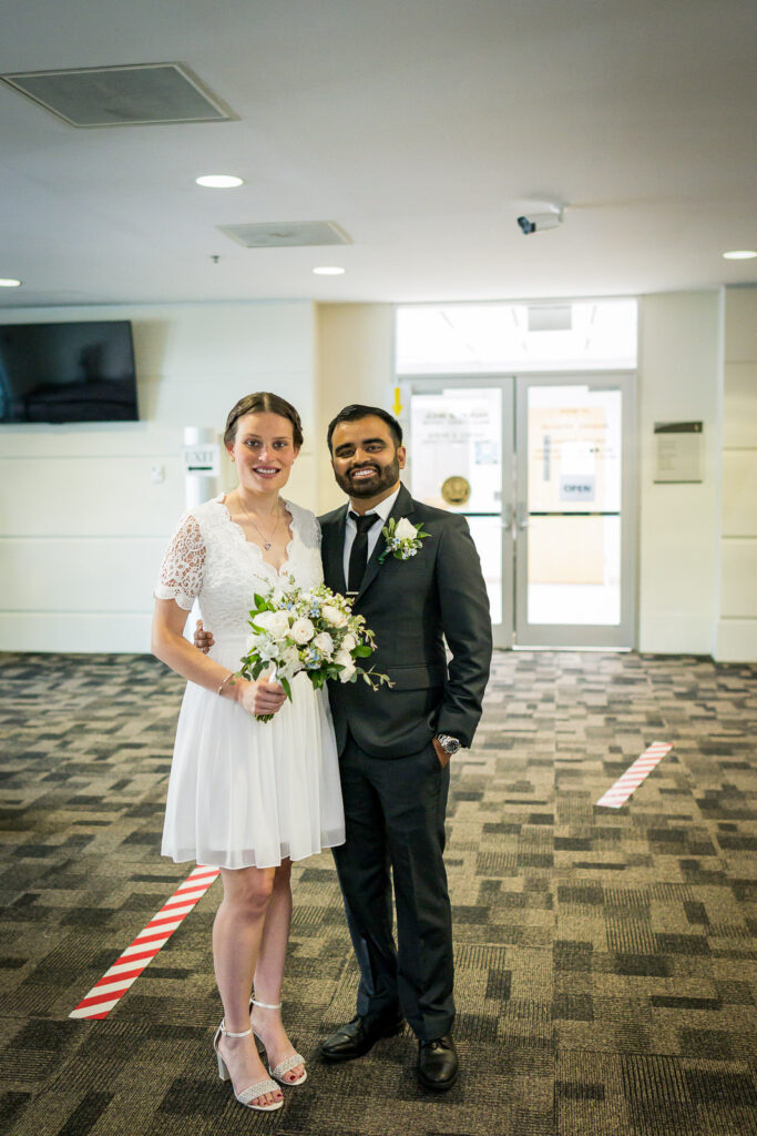 Couple portrait in Bergen County courthouse modern lobby by Alex Kaplan Photography