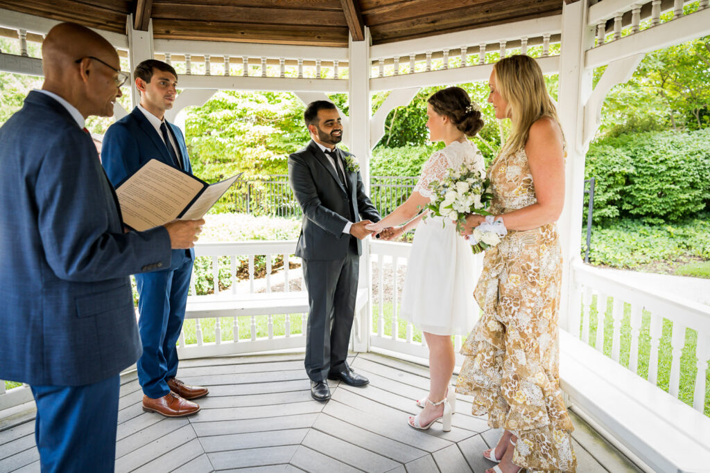 Ring exchange moment at Bergen County courthouse gazebo wedding photographed by Alex Kaplan