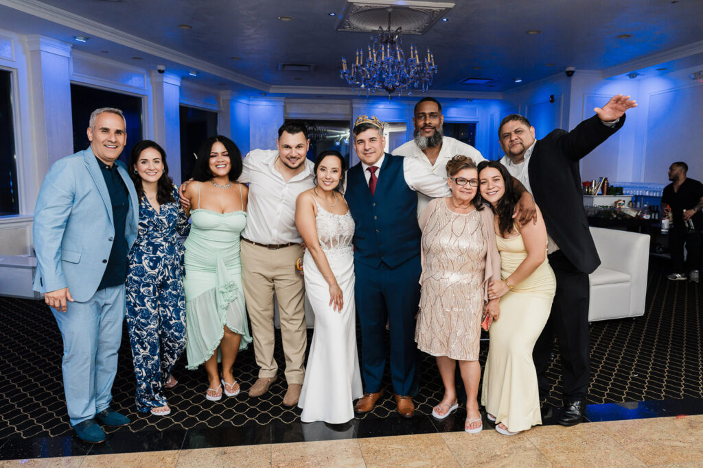 Extended family group portrait at Bergen County courthouse wedding reception by Alex Kaplan Photography