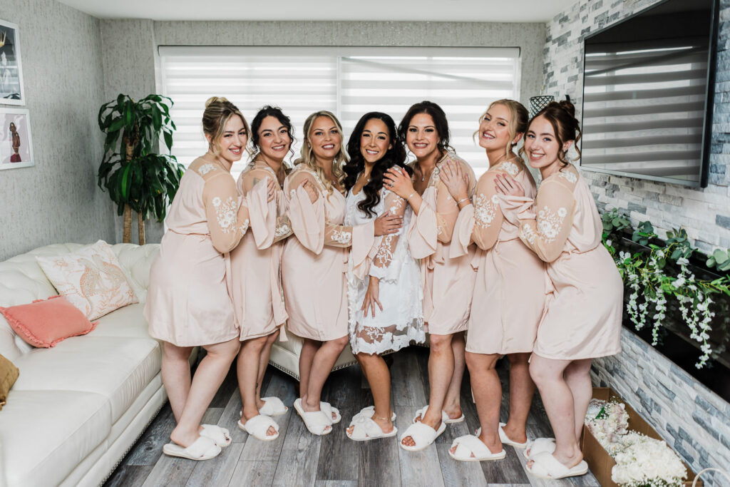Bride with bridesmaids in blush robes getting ready before The Grand Totowa wedding
