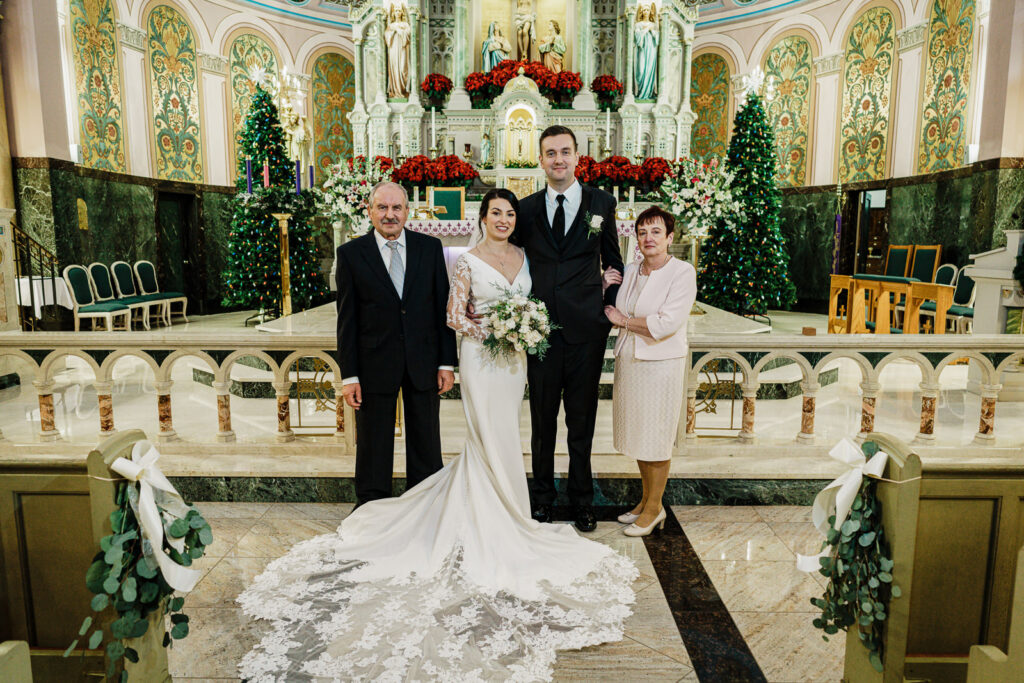 Bride with family at church altar by Alex Kaplan Photography
