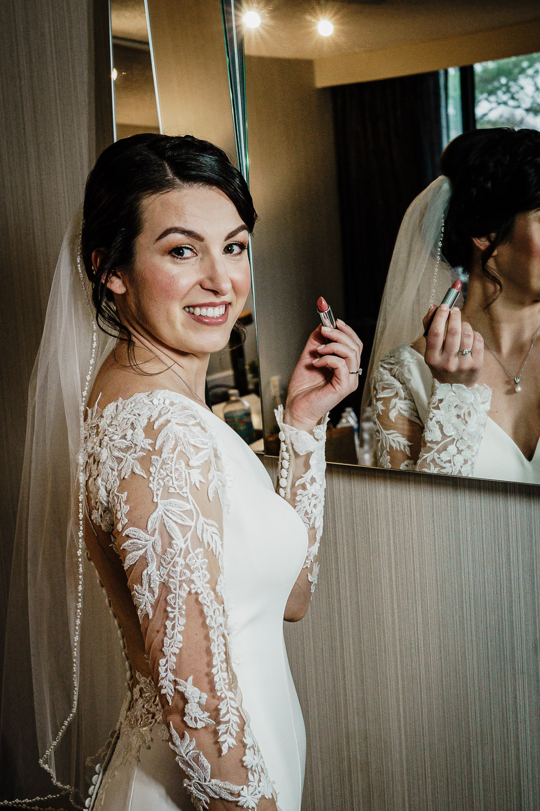 Bride getting ready in soft window light before New Jersey wedding