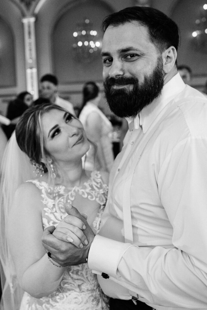 Bride Lindsay and groom John dancing and smiling during reception at Lucien's Manor captured by Bergen County photographer Alex Kaplan