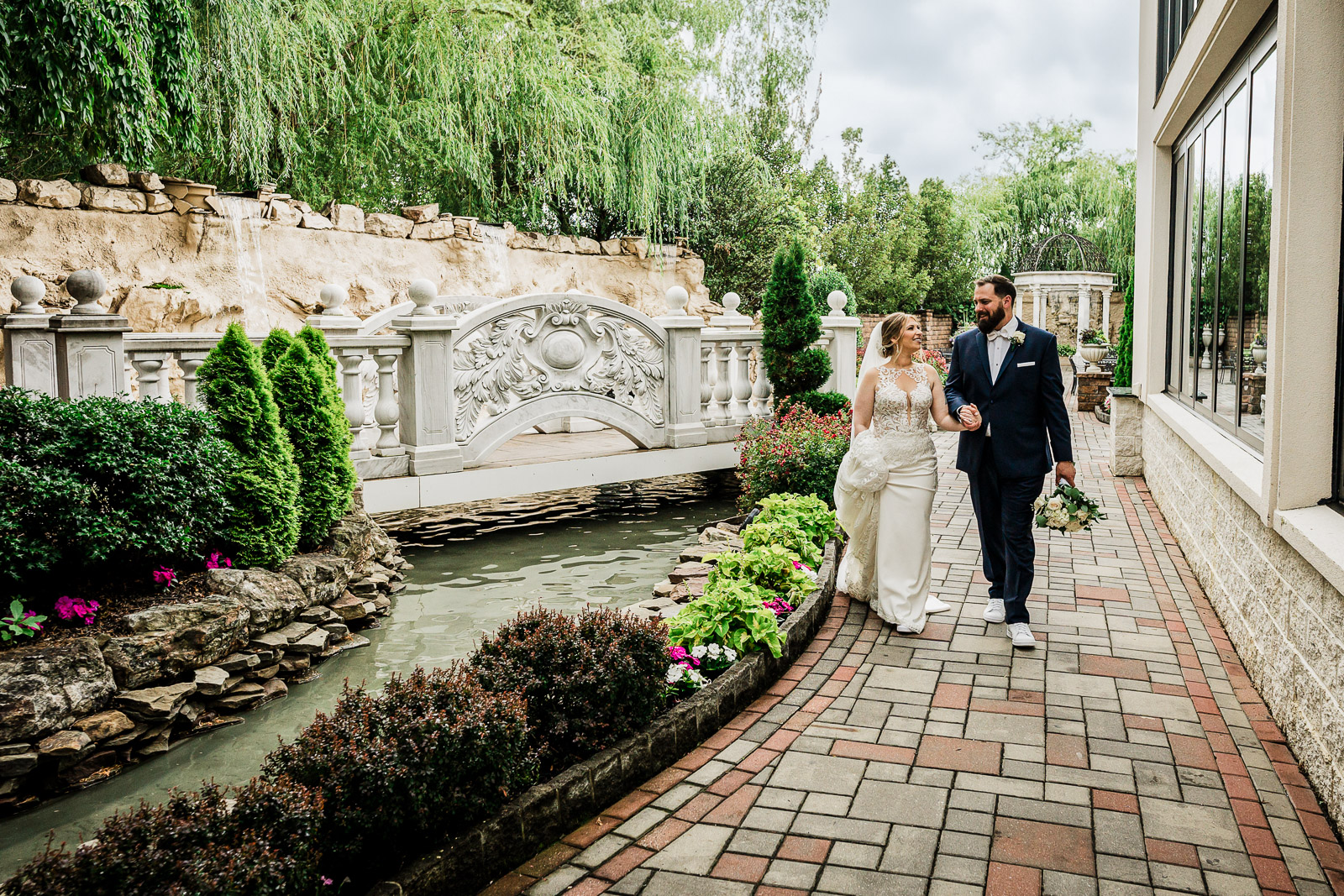 Couple sharing their first look at an outdoor New Jersey wedding venue on a sunny day