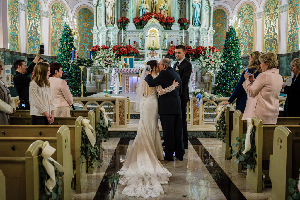 Father giving away bride at church altar by Alex Kaplan Photography
