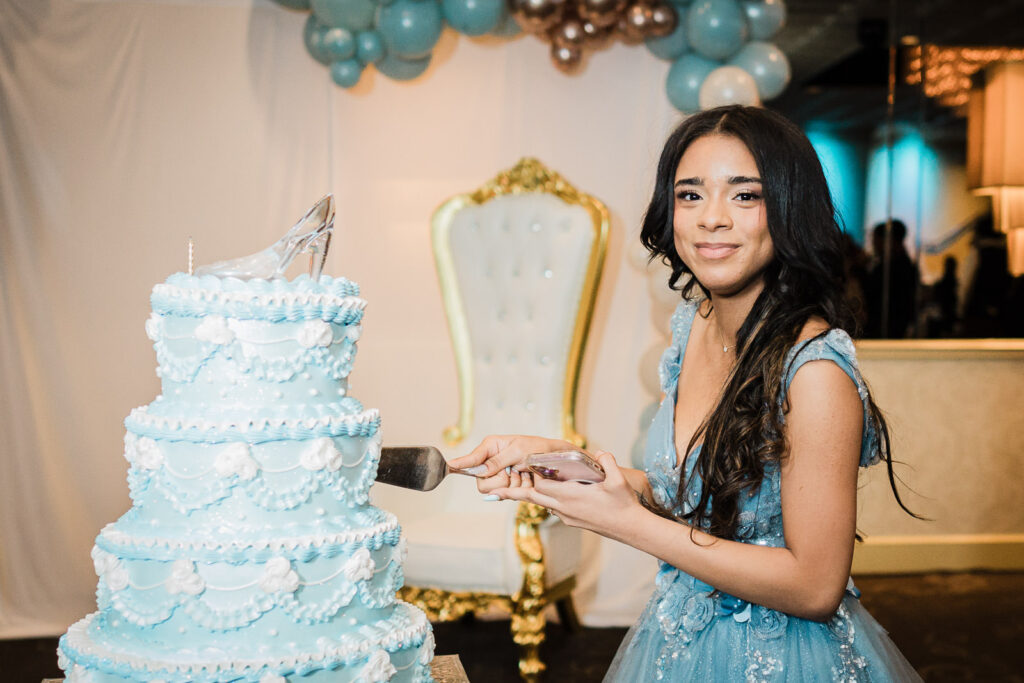 Birthday girl cutting four-tier Winter Wonderland cake at The Elan Lodi NJ Sweet Sixteen