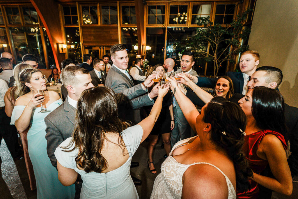 Wedding party toasting during reception at The Conservatory at Sussex County Fairgrounds photographed by Alex Kaplan
