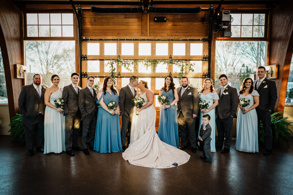 Complete wedding party with bridesmaids in blue and groomsmen in gray at The Conservatory photographed by Alex Kaplan