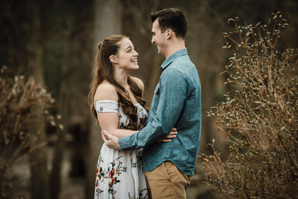 Couple laughing together during winter engagement session at Sayen House and Gardens Hamilton Township