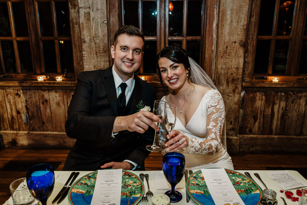 Newlyweds toasting at Rat's Restaurant reception by Alex Kaplan Photography