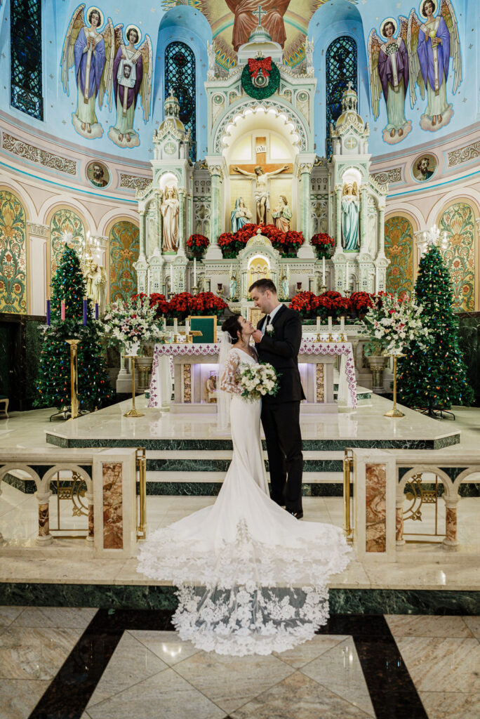 Married couple walking down church aisle by Alex Kaplan Photography