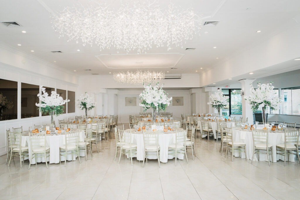 Elegant white ballroom with tall orchid centerpieces at Riverview Ballroom Cliffside Park NJ wedding reception