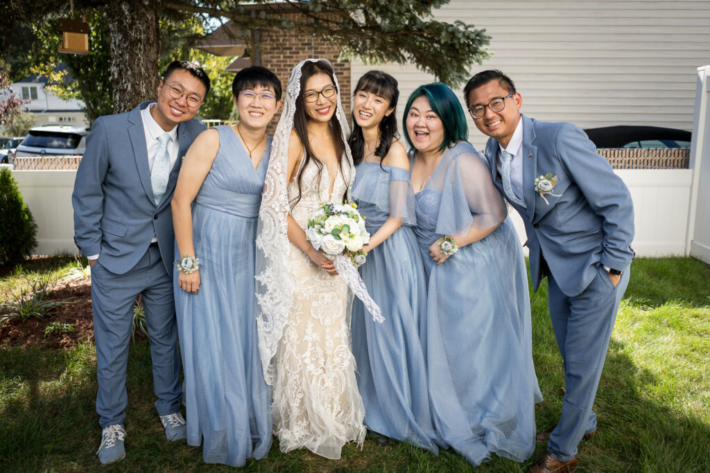 Bride with bridesmaids in dusty blue at Fair Lawn backyard wedding