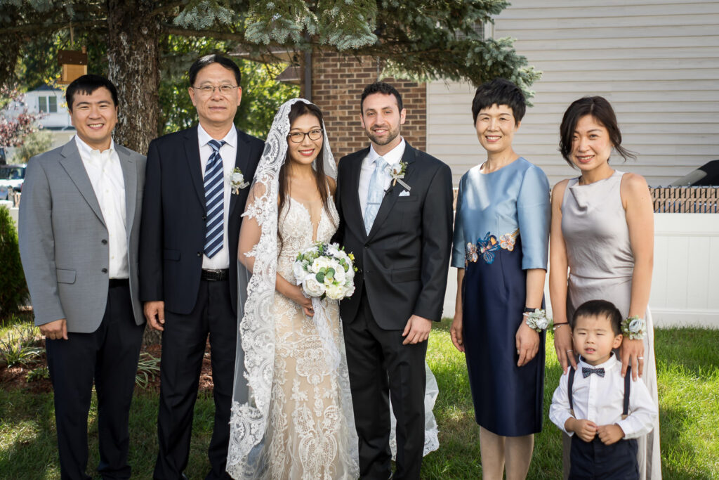 Bride's family portrait with ring bearer at Fair Lawn home wedding