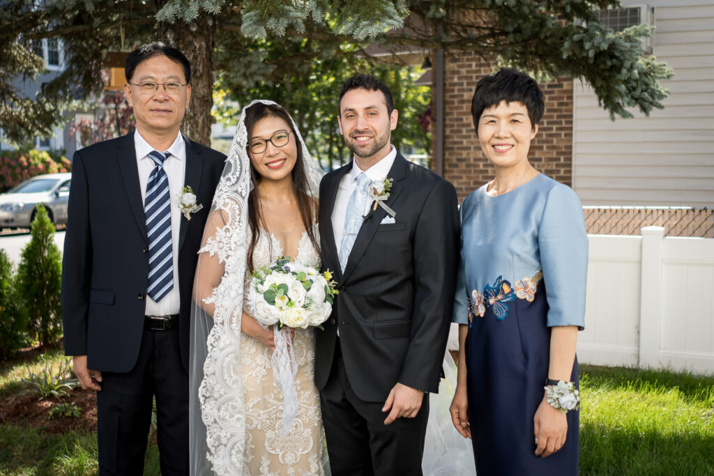 Bride with parents at Fair Lawn backyard wedding