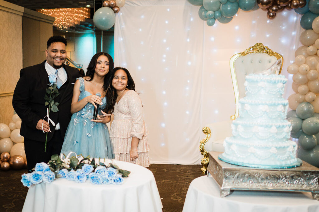 Brother and sisters with birthday girl by cake at The Elan Lodi NJ Sweet Sixteen