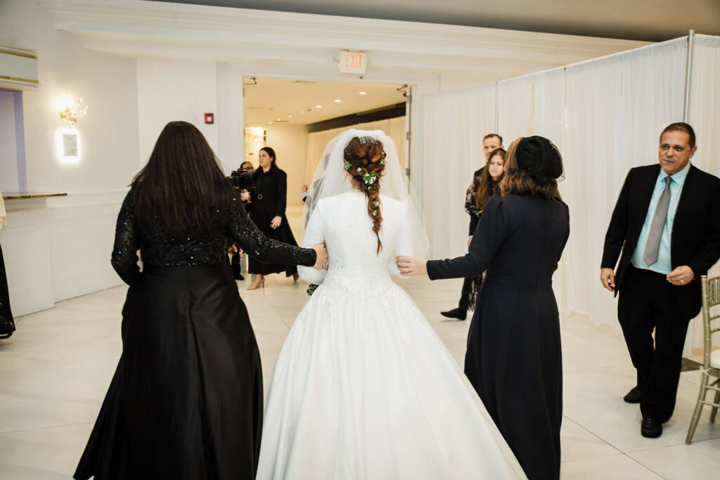 Father and son emotional hora dance moment at Riverview Ballroom Orthodox Jewish wedding Cliffside Park