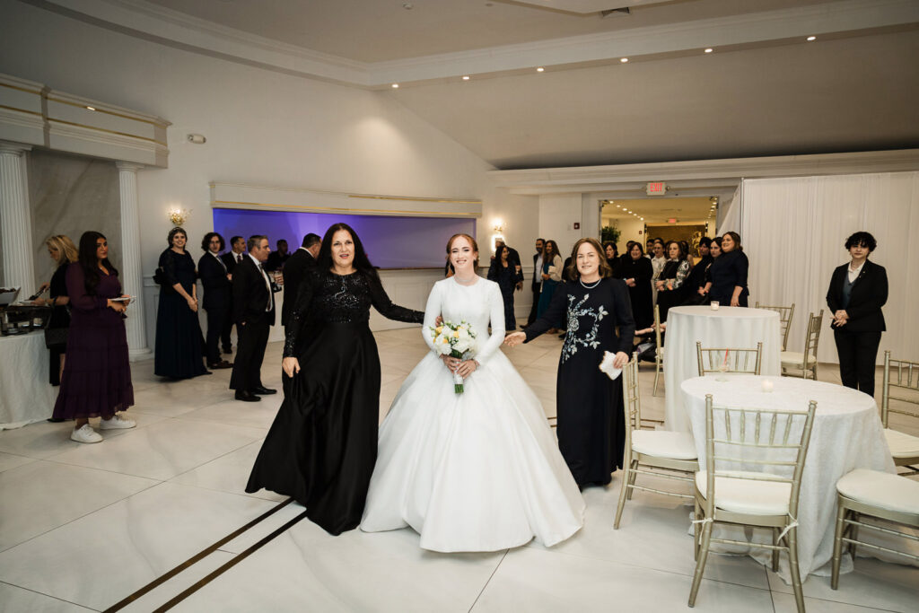 Bride grand entrance with mothers at Riverview Ballroom Orthodox Jewish wedding reception Cliffside Park
