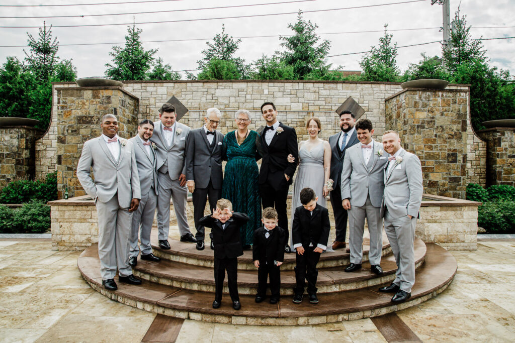 Groom side family group with three ring bearers fountain The Grand Totowa
