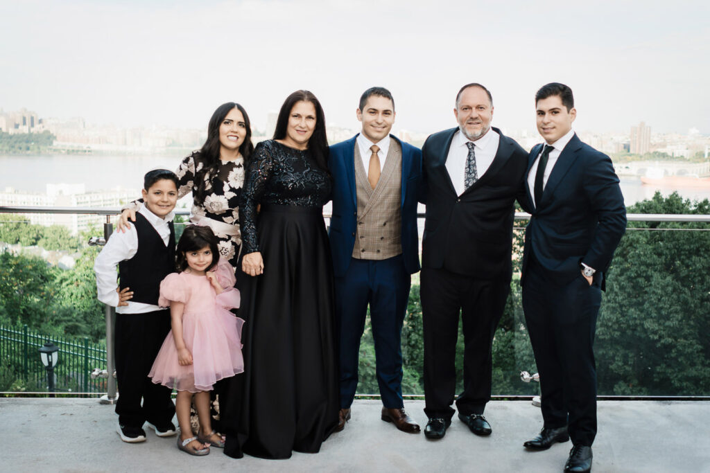 Groom with family on rooftop terrace with NYC views at Riverview Ballroom Cliffside Park NJ wedding