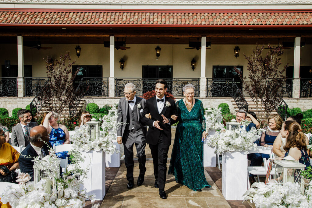 Groom Rob walking with parents down aisle outdoor ceremony The Grand Totowa