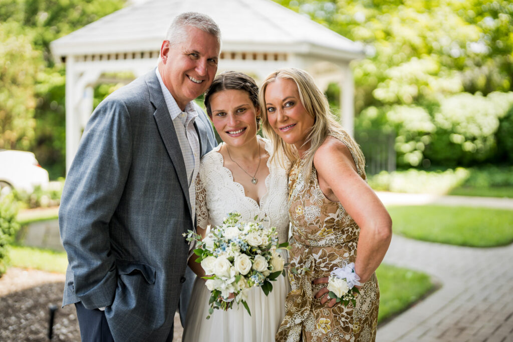 Bride with parents at Hackensack courthouse gazebo photographed by Alex Kaplan