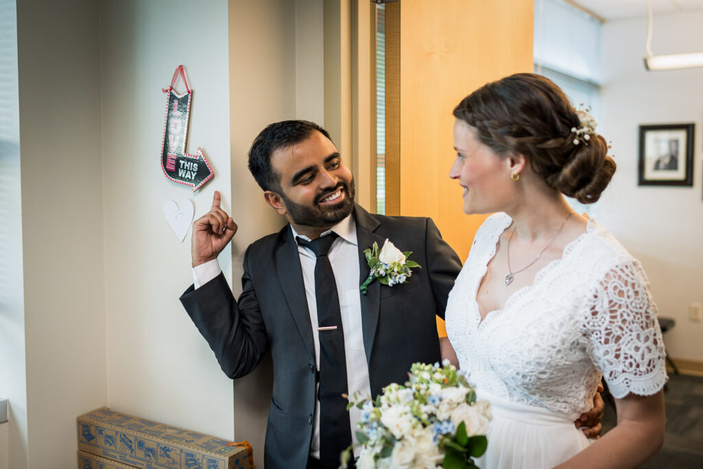 Joyful moment in Hackensack courthouse hallway captured by Alex Kaplan wedding photographer