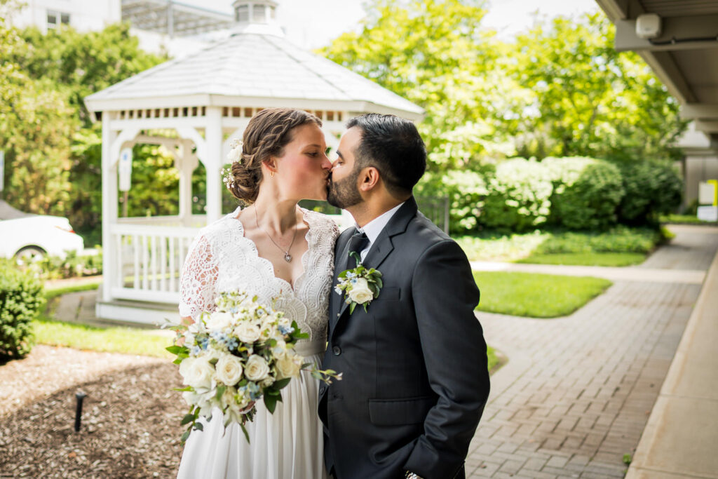 First kiss as married couple at Hackensack courthouse gazebo by Alex Kaplan wedding photographer