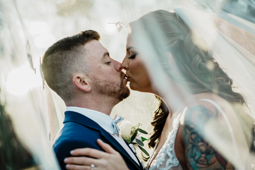 Intimate under the veil wedding portrait at Thompson Park NJ December wedding photographed by Monmouth County wedding photographer Alex Kaplan