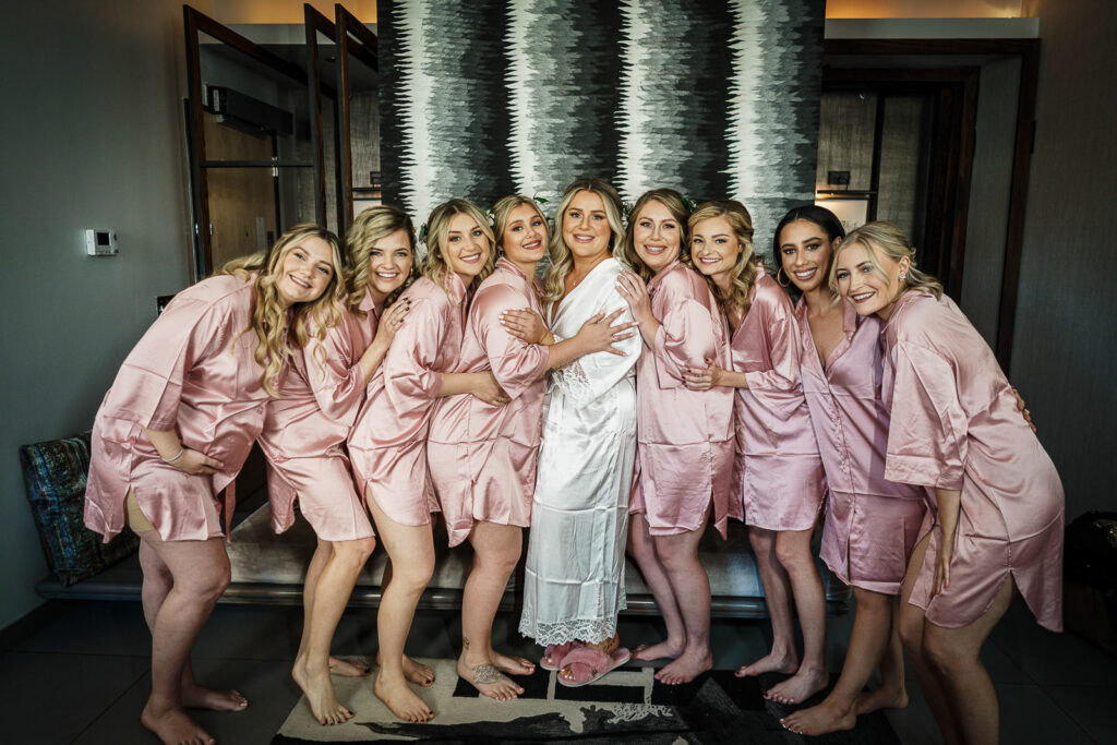 Bridal party in matching robes at Manhattan wedding by Alex Kaplan