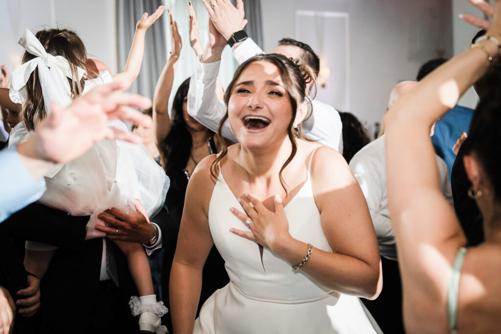 Bride showing genuine emotional reaction during reception at Mansion at Mountain Lakes