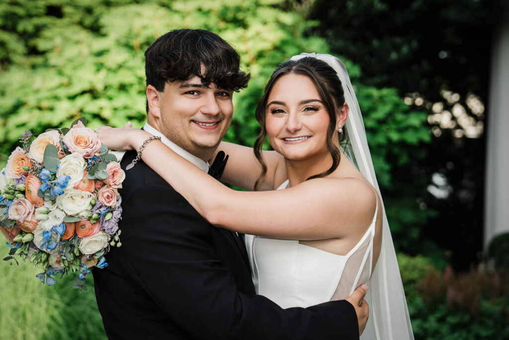 Bride and groom romantic outdoor portrait with natural greenery at Mansion at Mountain Lakes