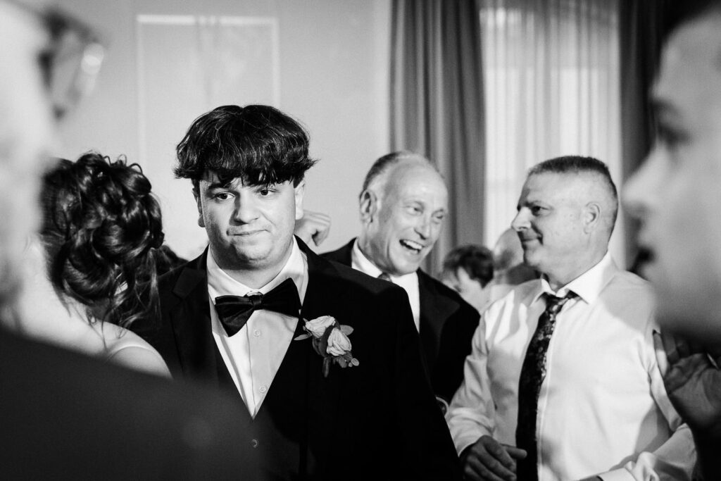 Groom celebrating on dance floor during Mansion at Mountain Lakes reception