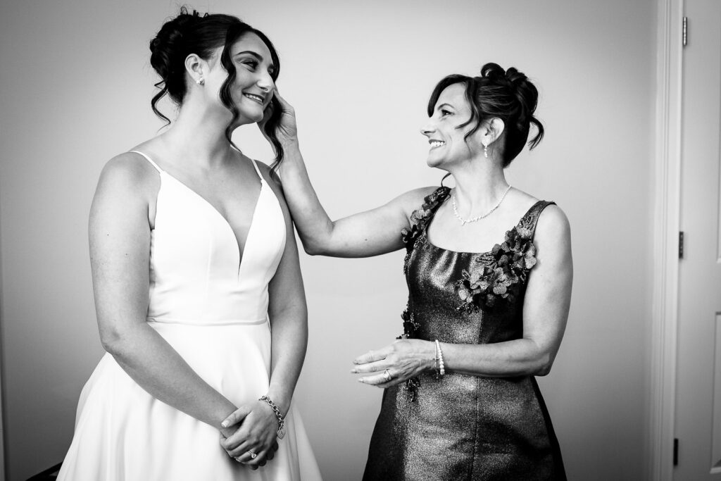 Mother of bride helping daughter prepare for wedding ceremony captured by Alex Kaplan Photography
