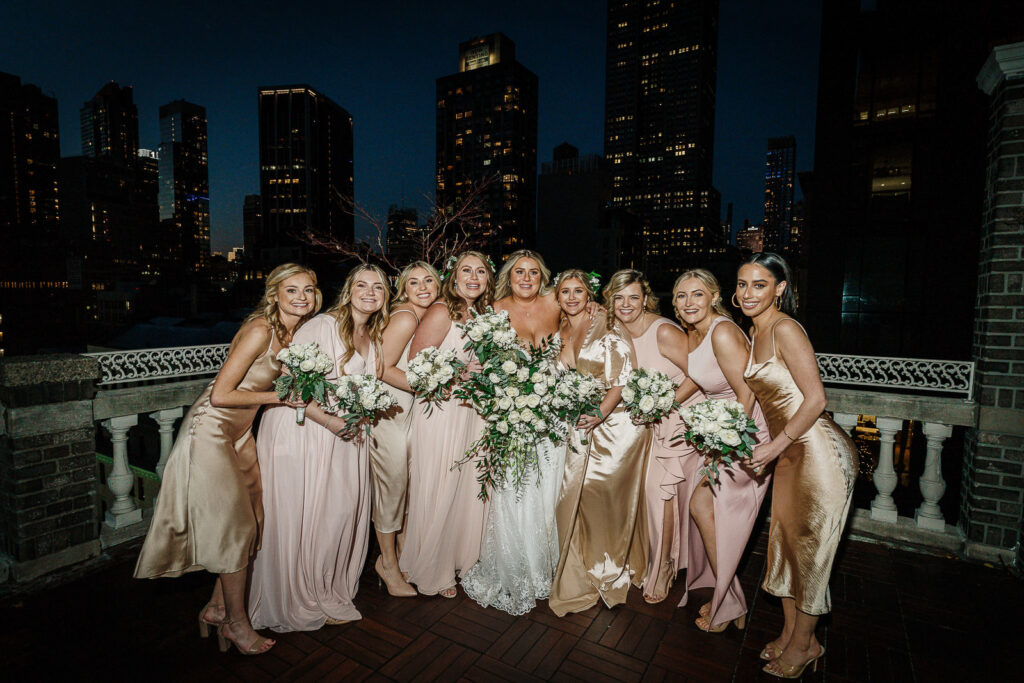 ridesmaids on Midtown Loft & Terrace rooftop with NYC skyline at sunset