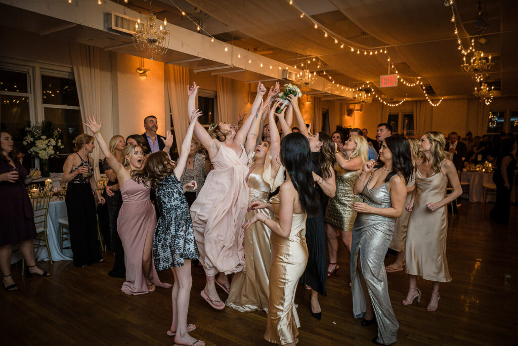 Guests catching bouquet at Midtown Loft & Terrace winter wedding NYC