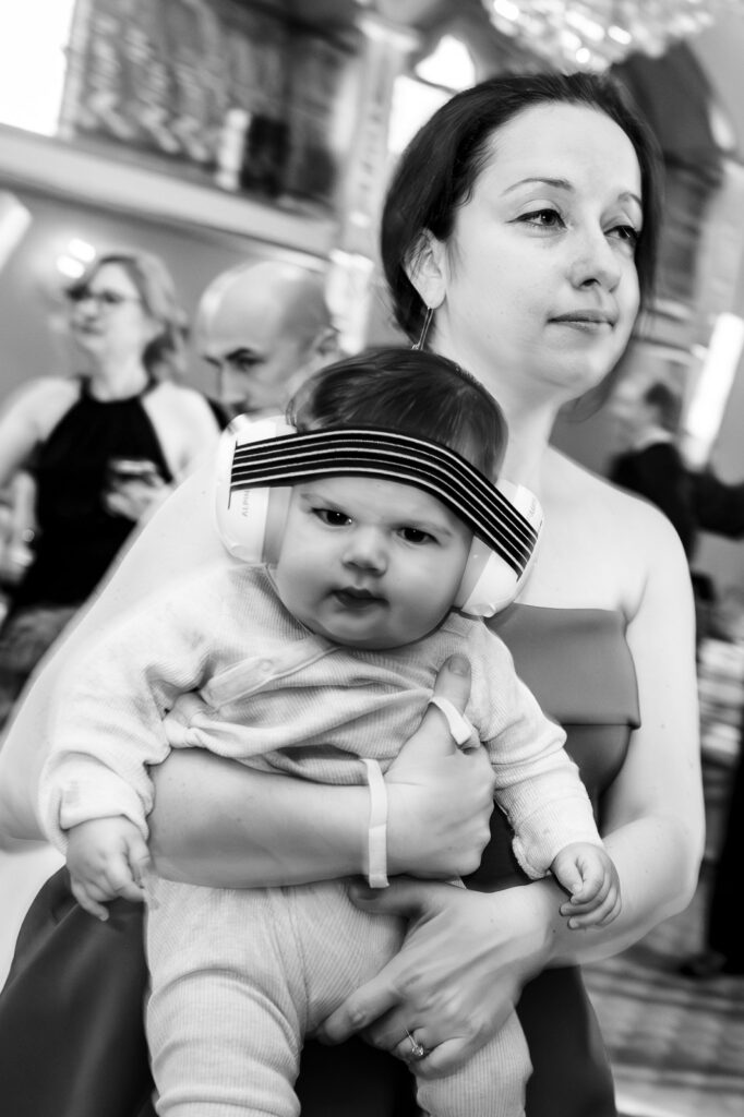 Mother holding baby during reception at Lucien's Manor Berlin NJ photographed by Alex Kaplan Photography