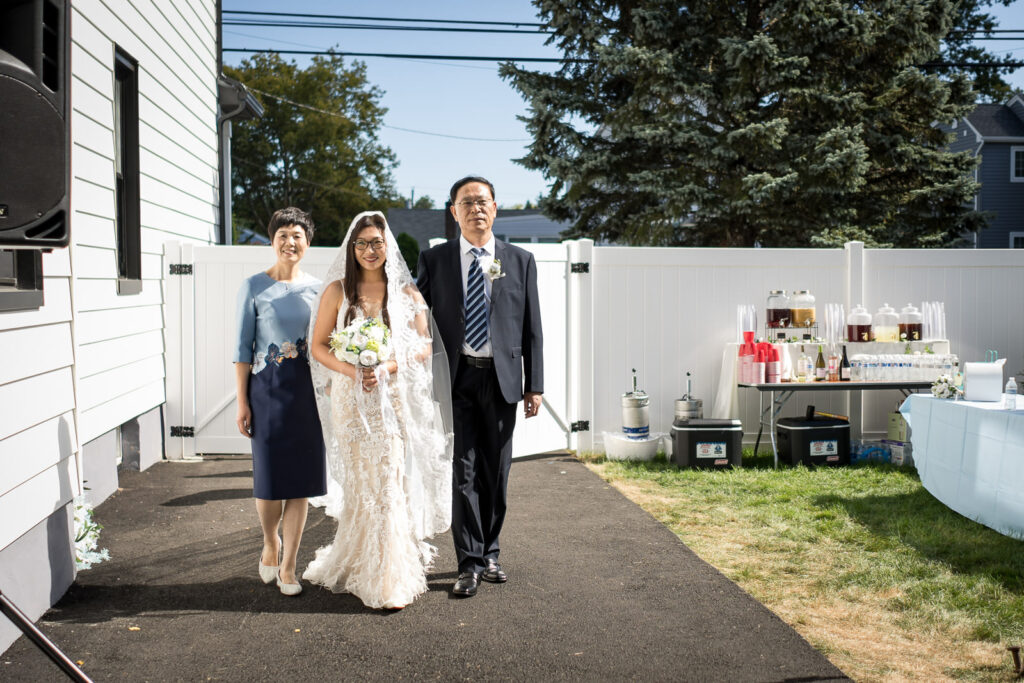 Bride walks down aisle with both parents at Northern NJ home wedding