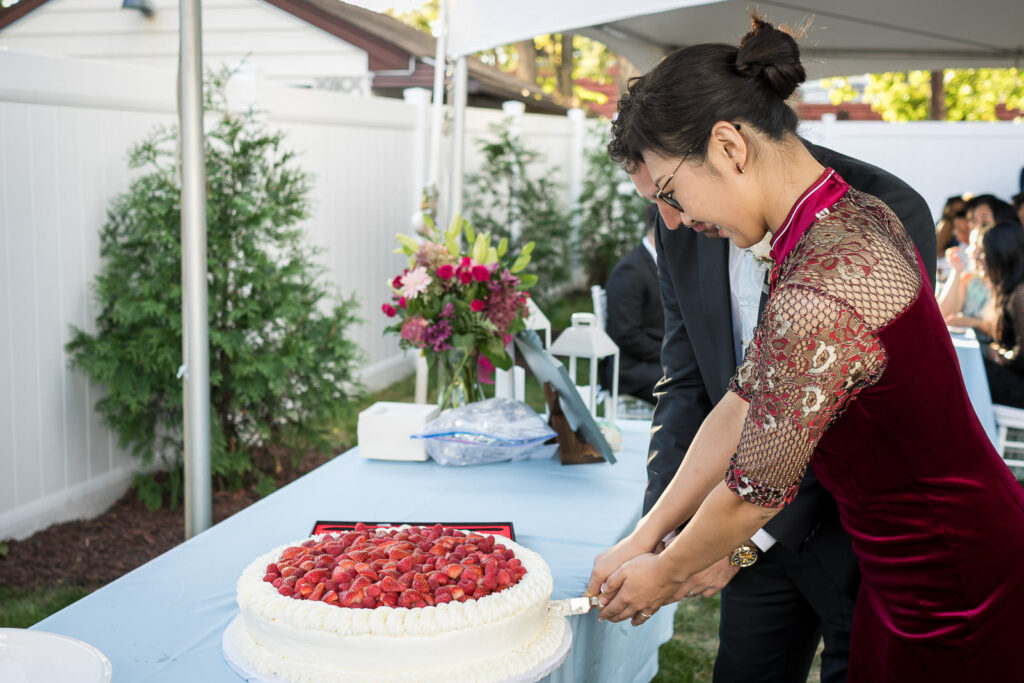 Cake cutting with bride in red qipao at Northern NJ home wedding