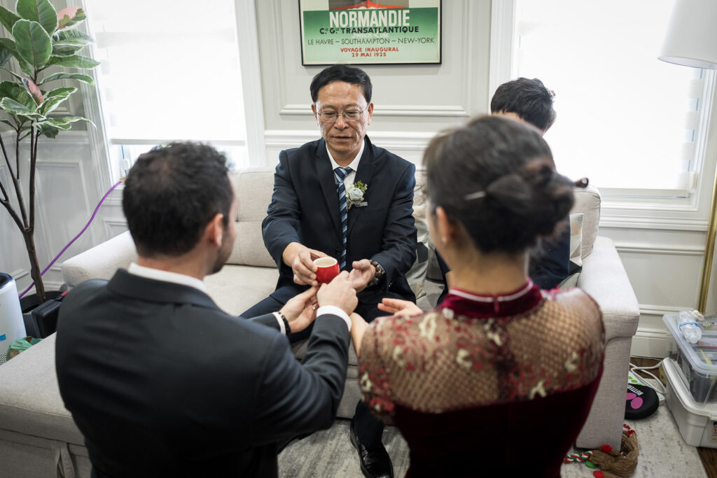 Couple kneels during Chinese tea ceremony at Northern NJ home