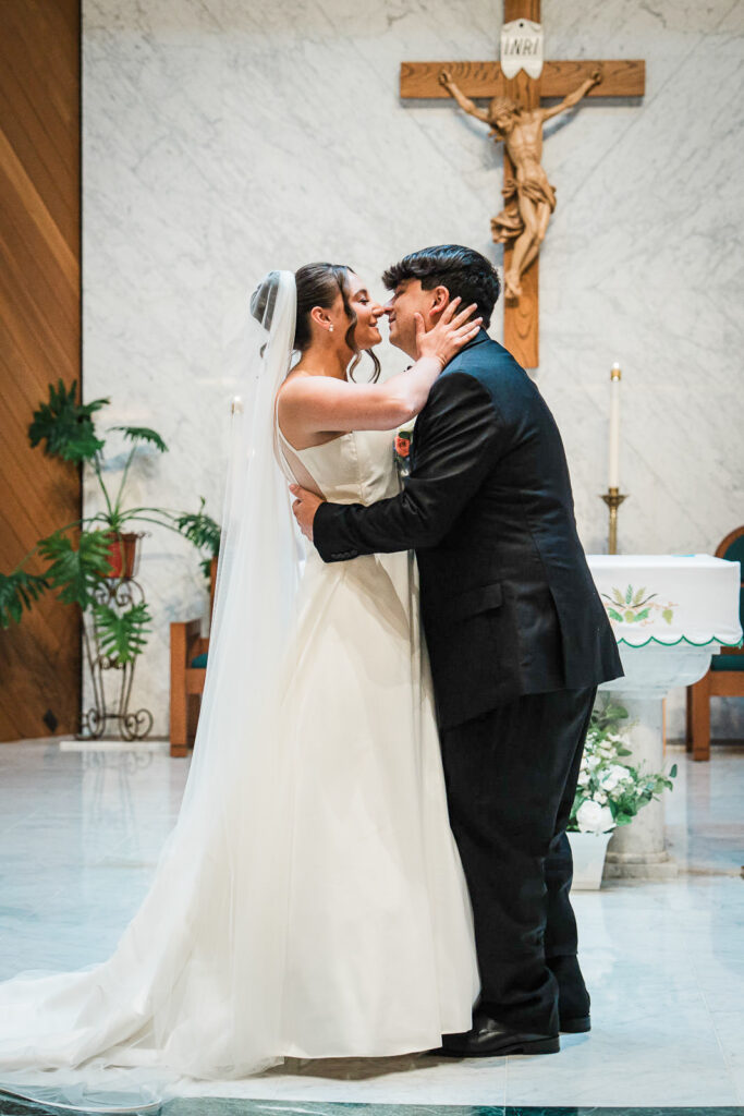 First kiss as married couple at altar of Notre Dame of Mt Carmel Church