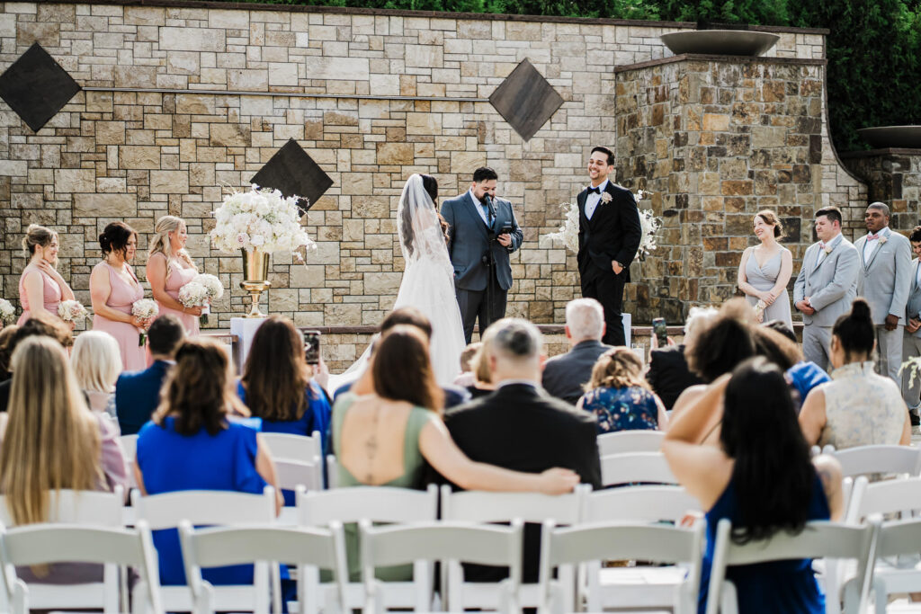 Outdoor ceremony from guest perspective with white chairs The Grand Totowa Totowa NJ