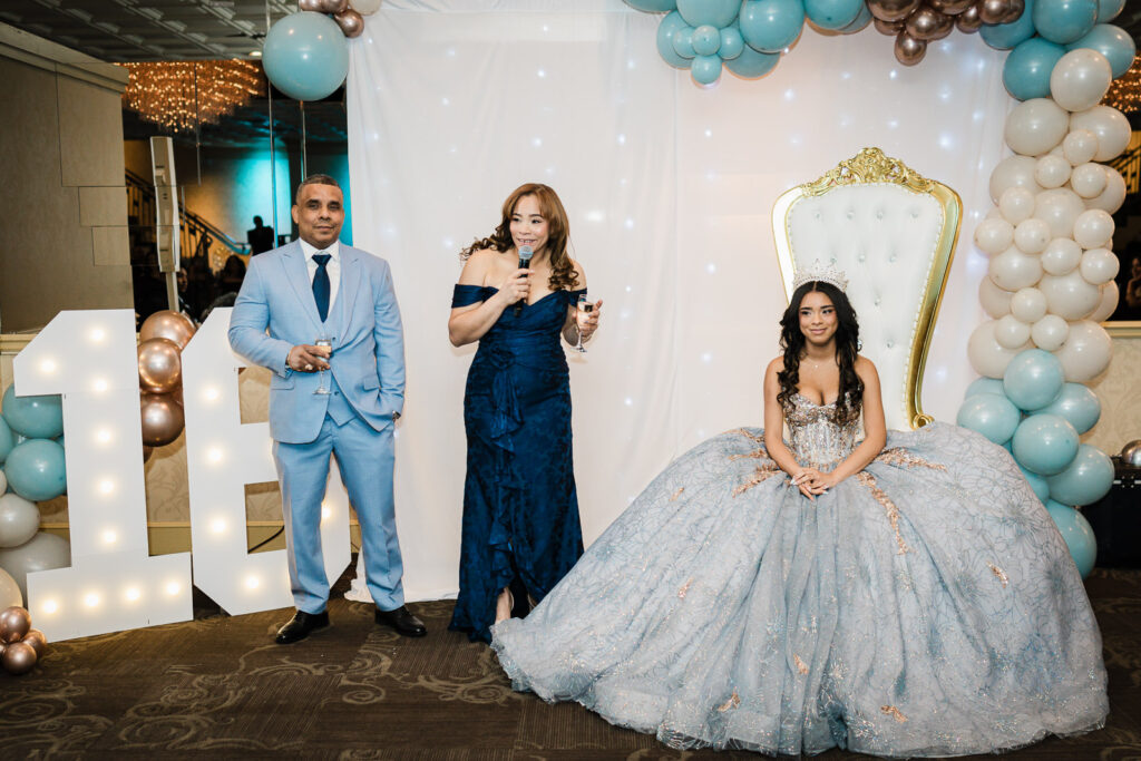 Parents giving toast at The Elan Lodi NJ Sweet Sixteen with daughter on throne