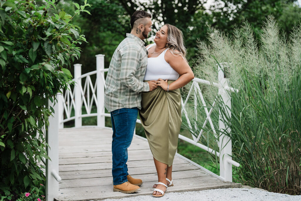 Intimate couple portrait on bridge Sayen Gardens Hamilton Square New Jersey engagement photography session