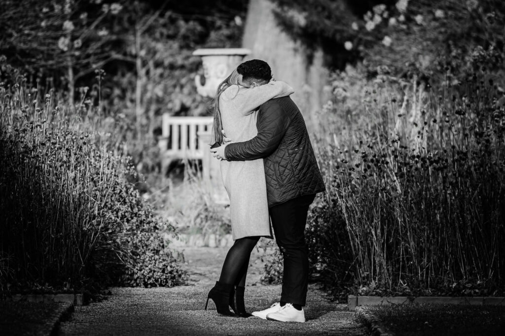 Black and white photo of engaged couple embracing after Van Vleck Gardens proposal in Montclair NJ