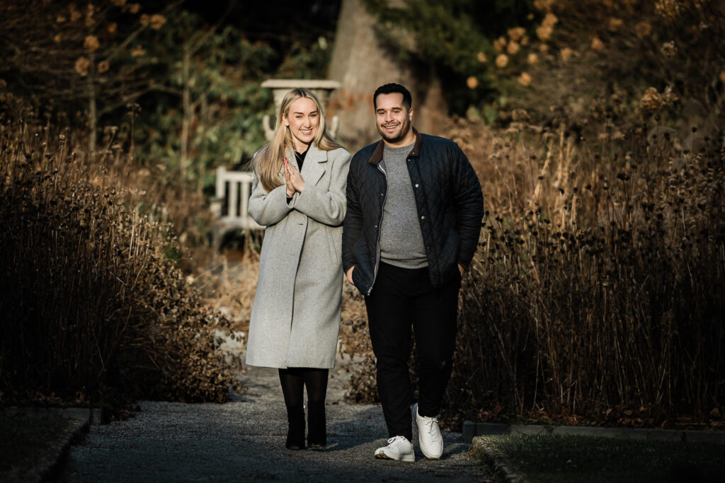 Happy newly engaged couple at Van Vleck House and Gardens Montclair showing engagement ring after she said yes
