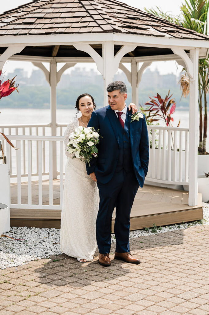 Couple at Waterside gazebo with New York City skyline and Hudson River by Alex Kaplan Photography
