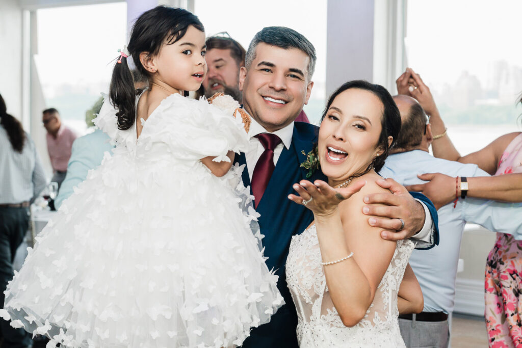 Bride and groom dancing with their young daughter at Waterside Restaurant reception photographed by Alex Kaplan